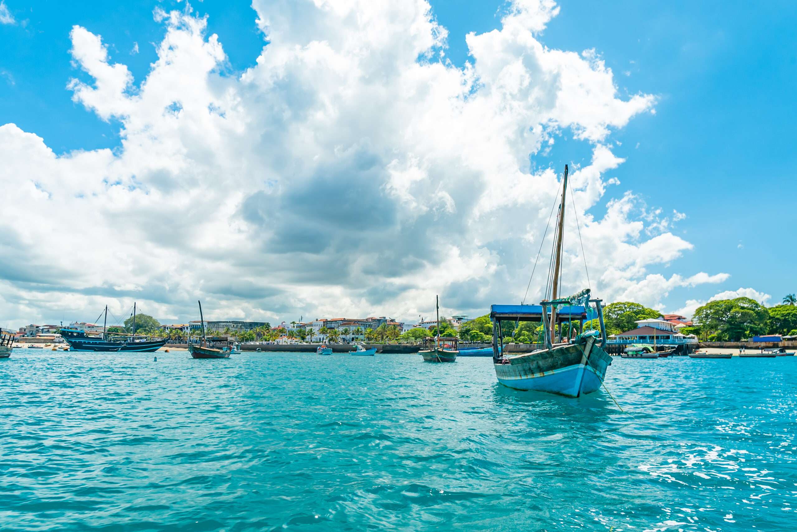 STONE TOWN, ZANZIBAR – DECEMBER 22, 2021: Boats in a port of Stone Town, Zanzibar, Tanzania